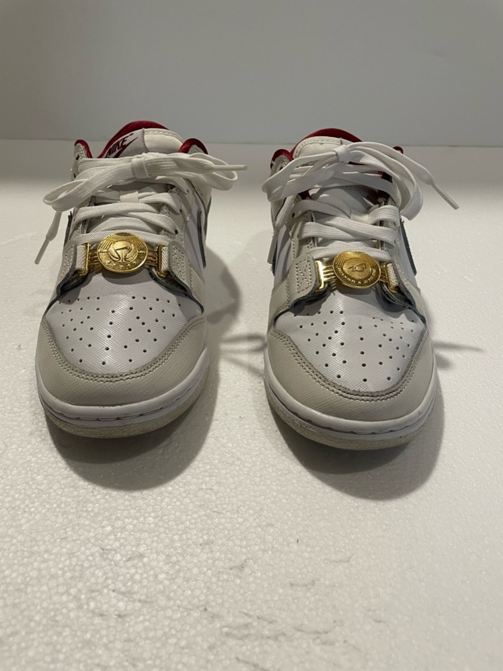 Nike Women’s White and Red Low-Top Sneakers with Gold Hardware